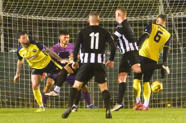 Thiago Da Silva (hidden) heads Dorchester's late leveller at Privett Park.
Picture: Keith Woodland