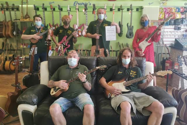 The team from Kouga Guitars in Stoke Road, Gosport with Caroline Dinenage MP