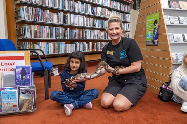 Arvita Shrivastava, five, meets the python named 'Dolly Python', cared for by Zoolab presenter Anna French. Picture: Mike Cooter (240922)