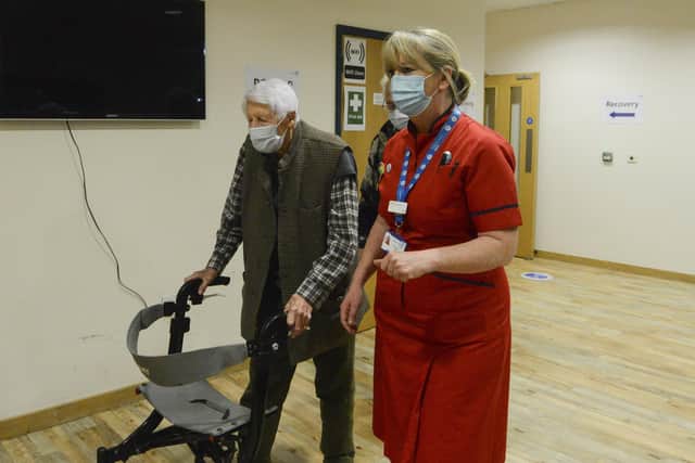 Michael Tibbs, 99, being taken through by Liz Rix, Chief Nurse, to receive his COVID vaccine.
Picture: Ewan Galvin/Solent News & Photo Agency