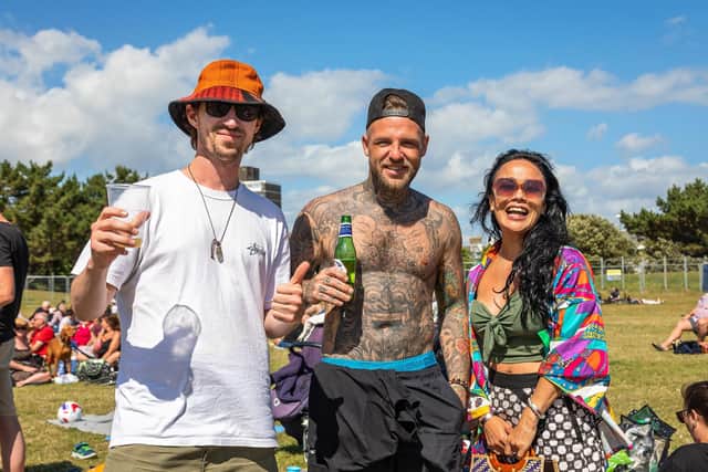 Jason, Dave and Abby happy to be out in the sun at the return of the live music at the Band Stand. Picture: Mike Cooter (120622)