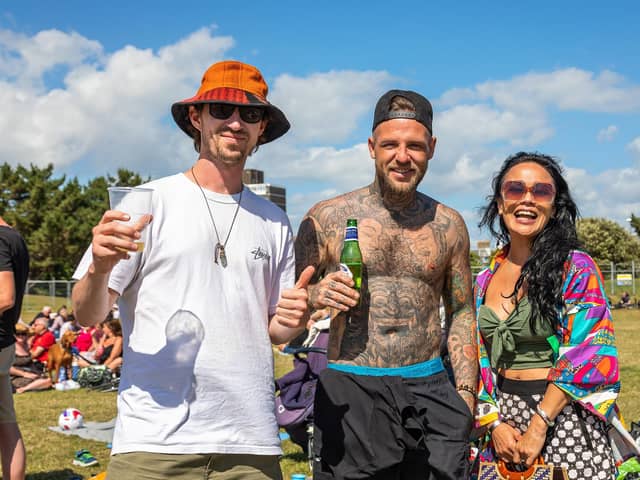 Jason, Dave and Abby happy to be out in the sun at the return of the live music at the Band Stand. Picture: Mike Cooter (120622)