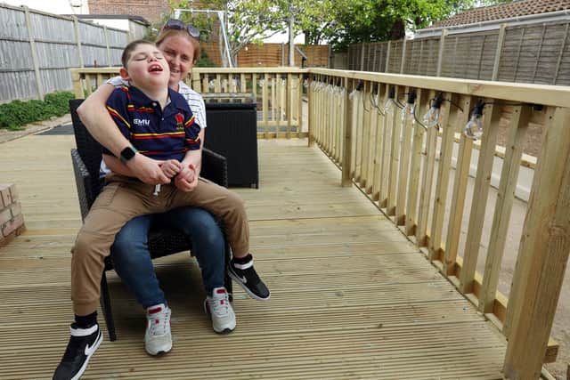 Archie Cleaver, 10, and his mother, Victoria Cleaver, have had their Paulsogrove garden made over by representatives from Propp, Glenhawk Finance, MT Finance, Together Finance and Helping Hands at Wellchild. Picture: Chris Moorhouse (jpns 040522-39).