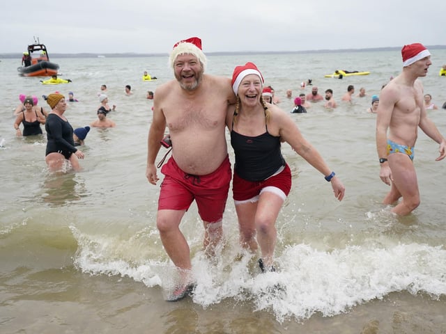 People take part in the Gosport New Year's Day Dip in The Solent at Stokes Bay, Gosport, Hampshire, to raise money for Gosport and Fareham Inshore Rescue Service.