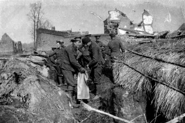 Soldiers from the London Rifle Brigade filling sandbags at Le Gheer at Christmas 1914.