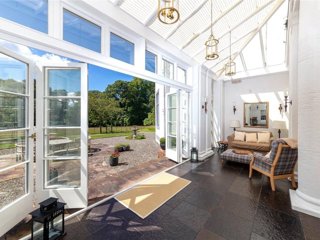 The conservatory leads out on to the beautiful grounds within the estate. The grounds are formed predominantly of mixed woodland, boasting historic yew trees and herbaceous borders and shrubs