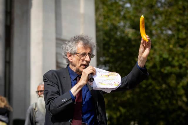 Bananas: Piers Corbyn waggles a plastic banana in the air as he told the crowd they shared DNA with the popular yellow fruit
Picture: Habibur Rahman