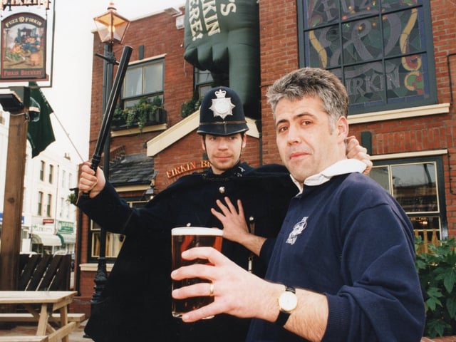 Andy Davies-Macleod, the landlord of the Fuzz and Firkin, is 'nicked' by Simon Millard, the bar supervisor durin ghte fun at the opening of the new pub, formerly Southsea Police Station in Albert Road, Southsea in February 1996 PP1513
