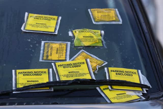 Parking charge notices plastered on a car windscreen
