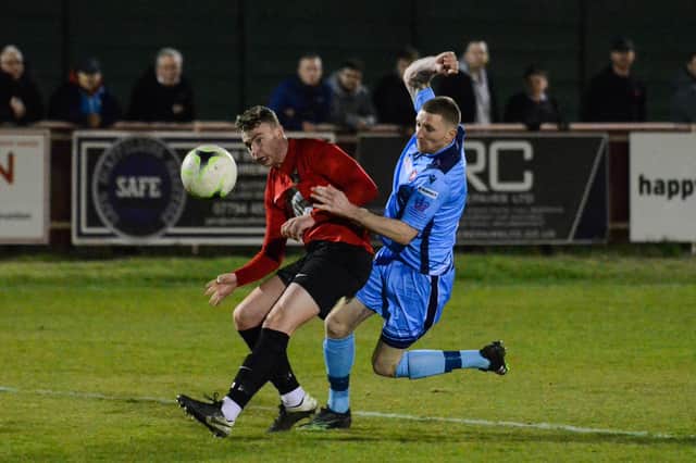 Fareham's Archie Willcox, left, and Portchester striker Lee Wort. Picture: Daniel Haswell