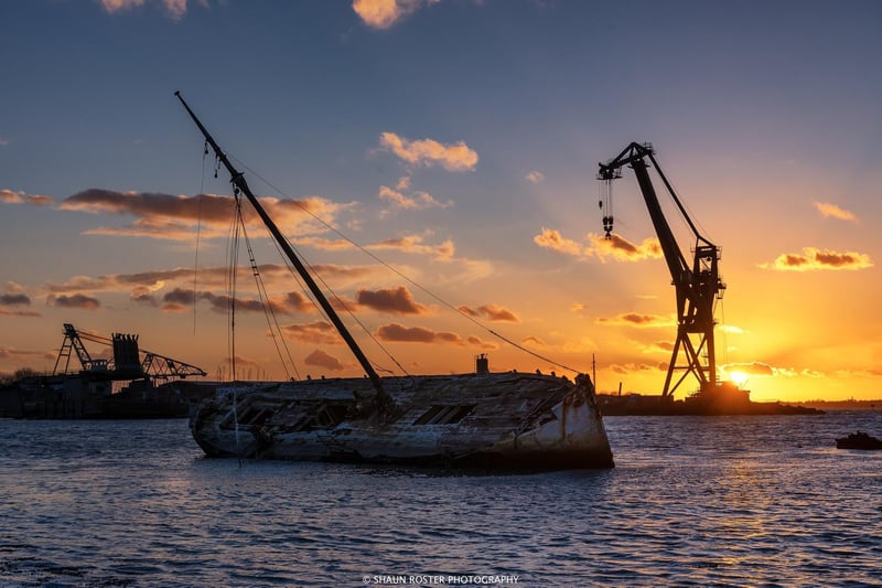 The old wreck with the sun setting through the monster crane of Pounds Yard, Tipner taken by Shaun Roster.