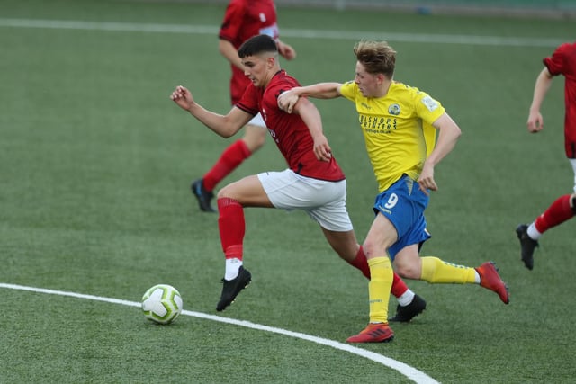 Hawks' Liam Brewer and Camberley's Ollie West. Picture by Dave Haines.
