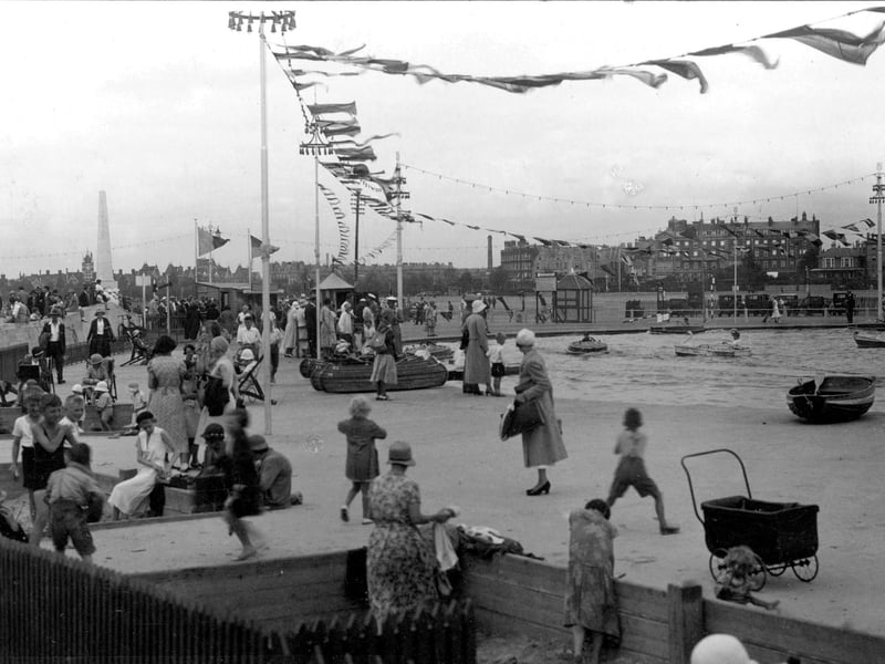 A windy day at the children's boating pool on Southsea Common. In the background you can see (from left) the obelisk of Portsmouth Naval War Memorial, the power station chimney and the Queen's Hotel taken late 1920's or early 1930's. Picture: Paul Costen collection