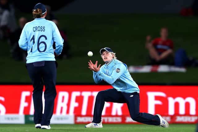 Charlie Dean takes a catch during the 2022 ICC Women's Cricket World Cup Semi Final match between South Africa and England. Photo by Phil Walter/Getty Images.