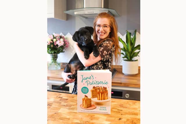 Jane with her new cookbook and dog Thor.