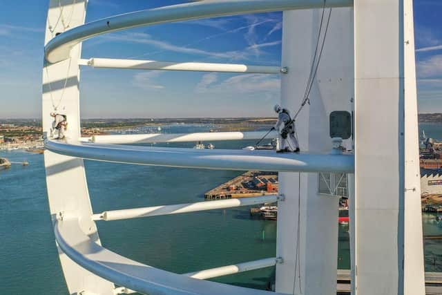 default:Drone photographer captures the amazing moment where two painters were suspended in the air to paint Spinnaker Tower.
Picture: Hugo Healy - Drone photographer