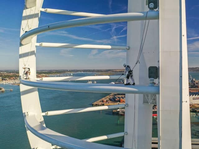 default:Drone photographer captures the amazing moment where two painters were suspended in the air to paint Spinnaker Tower.
Picture: Hugo Healy - Drone photographer