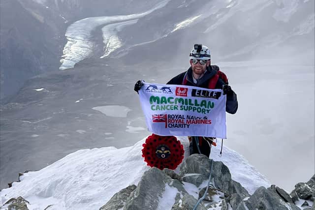 Lars Atkins atop the Matterhorn, with his MacMillan flag