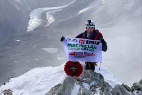 Lars Atkins atop the Matterhorn, with his MacMillan flag