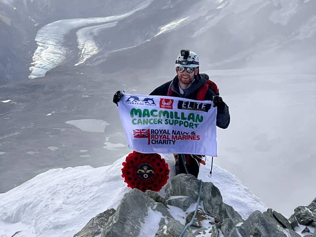 Lars Atkins atop the Matterhorn, with his MacMillan flag