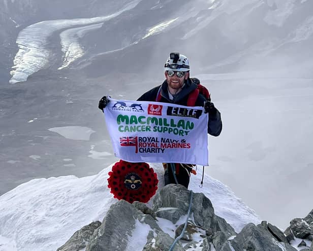 Lars Atkins atop the Matterhorn, with his MacMillan flag