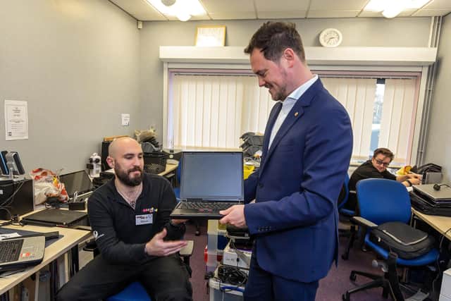 Steve Austin (34), a participant working in the Repair Shop, shows one of his refurbished laptops to Stephen Morgan MP. Picture: Mike Cooter (311021)