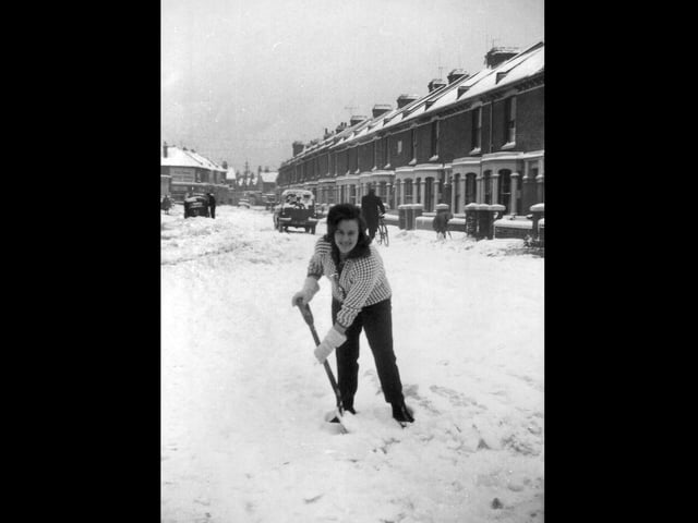 Wendy Stacey clearing snow in Fawcett Road, Southsea, during the winter of 1963