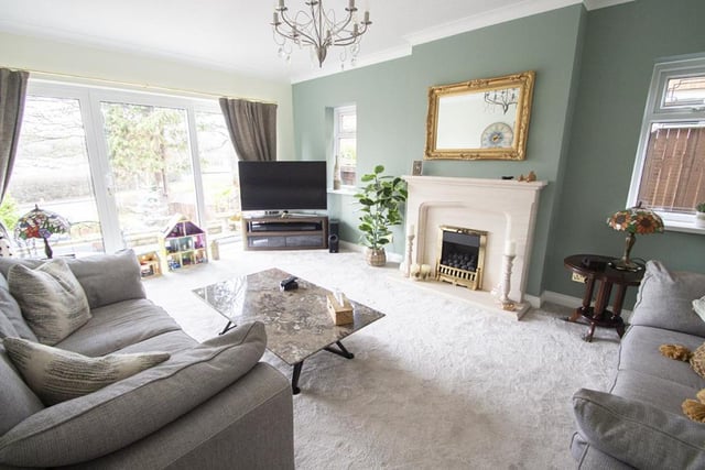 The bright spacious lounge features a modern fireplace.