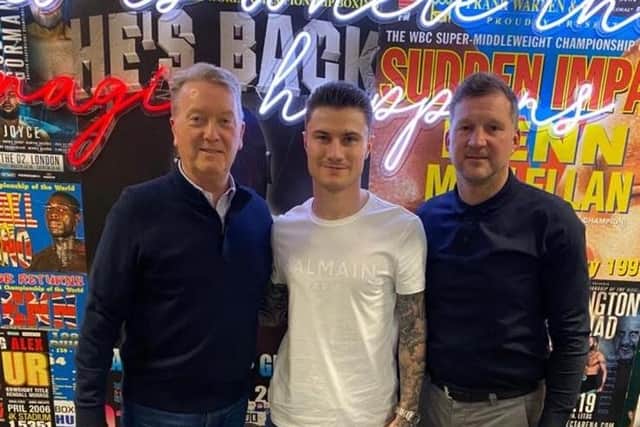 Jamie Chamberlain, centre, with trainer Wayne Batten, right, and promoter Frank Warren after signing his three-year deal