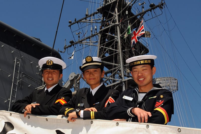 Welcome to our Japanese warship. (left to right)  PO3 Gunner Takafumi Harusaki, with  Assistant Engineer Officer Lt.JG Kaori Sei, and Leading Seaman and Operation Specialist Ippei Takeuchi from the JS TV Kashima , one of three Japanese ships from the Japan Maritime Self Defense Force (JMSDF). 24th August 2008. Picture: Malcolm Wells 083132-6961