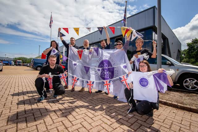 Staff at Hampshire Flag, Waterlooville with Jubilee bunting and flags on Tuesday.
Picture: Habibur Rahman