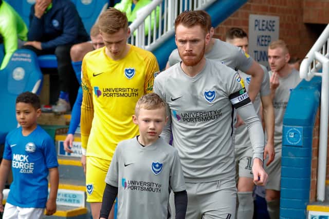Pompey captain Tom Naylor leads Pompey out for their recent game against Peterborough in League One
