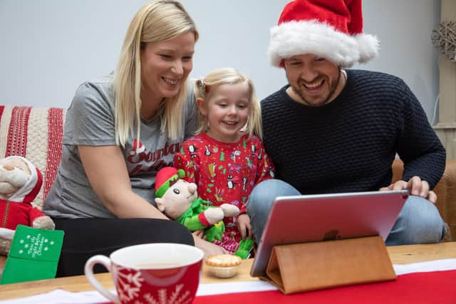 Simon Jenns, who has set up livevideosanta.com, with his daughter Lexi and wife Jo in their Denmead home. Picture from Steven Stringer. 