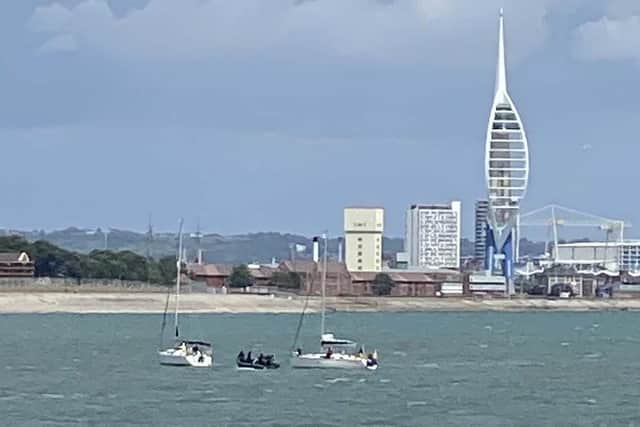 A boat from HMS Mersey joins another vessel to help a stricken yacht with steering difficulty. Photo: Royal Navy