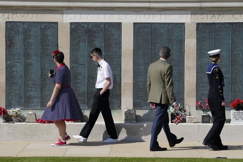 People look at the names on the Portsmouth Naval Memorial ahead of  the UK's national commemorative event for the 80th anniversary of D-Day, hosted by the Ministry of Defence on Southsea Common in Portsmouth, Hampshire.Photo credit should read: Andrew Matthews/PA Wire:D-Day