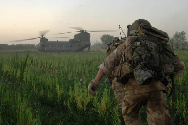 Image shows: Soldiers of 9 Platoon running up to a Chinook Helicopter for extraction in Afghanistan