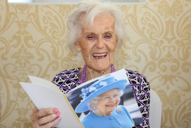 Edna Blott celebrated her 100th Birthday with all her family on Saturday afternoon at the Brookfield Hotel in Havant.Pictured - Edna Blott opening her 100th Birthday Card from The Queen.Photos By Alex Shute