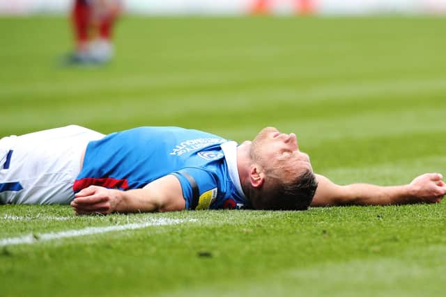 Defender Lee Brown lies injured on the floor after picking up a hamstring injury against Burton.