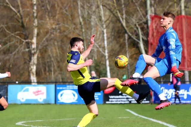 Gosport Borough's Bradley Tarbuck, left, is beaten to the ball by onrushing Kings Langley goalkeeper Alfie Marriott Picture: Tom Phillips