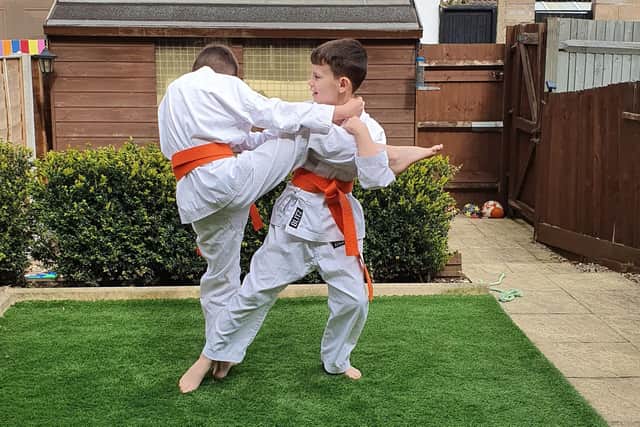 Karate kids Mark Hague, 10, and brother Myles, nine, practise some of their sweeps and throws.  Photo: Pauline Hague