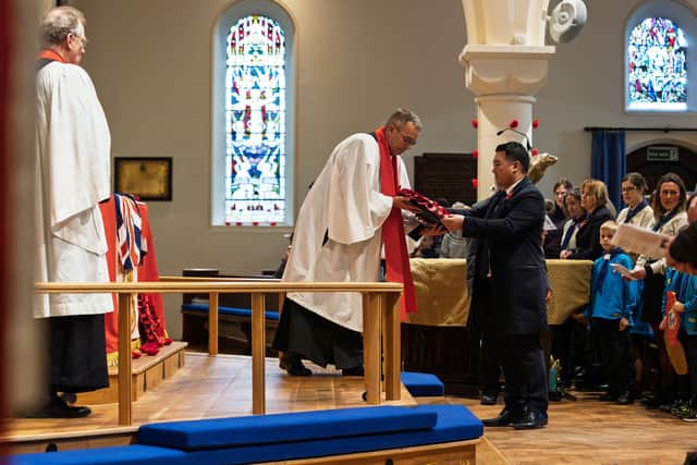 Alan Mak MP lays a wreath during a Remembrance Sunday service at St James' Church in Emsworth
