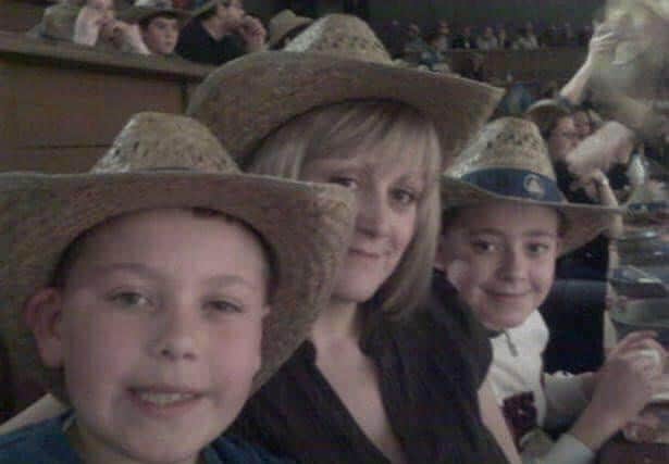Karen (Centre) with her two sons Harry (Right) and Tom (Left)