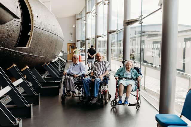 Peter, Peter, and Rowena exploring different submarines at the museum
