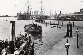 A view of the dockyard about 1908 with Gosport ferries in the foreground. The railway line opened in 1876. It was built as part of the harbour extension across the foreshore of Watering Island. The jetty here was constructed in 1860 and was especially suitable for troopships