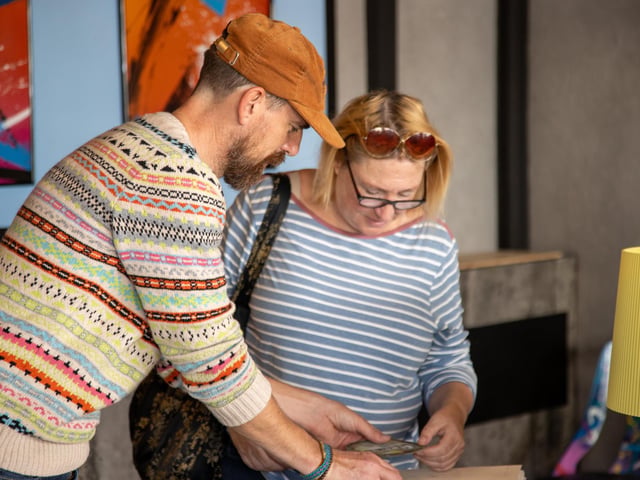 Local residents were invited to join the Southsea Mini Art Trail on Sunday, with various local artists displaying their work around Albert Road and the surrounding area.
Pictured - Artist John Ainsworth, also known as 'When We Were Cows' with customer Steph Ginns
Photos by Alex Shute