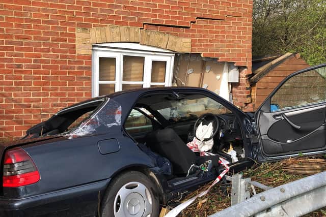 The car pictured embedded into the house in Caer Peris View, Portchester, following a botched police chase. Photo: Tom Cotterill