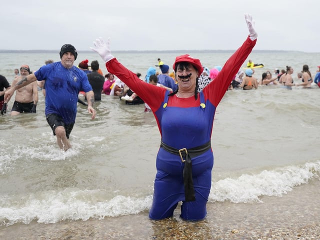 People take part in the Gosport New Year's Day Dip in The Solent at Stokes Bay, Gosport, Hampshire, to raise money for Gosport and Fareham Inshore Rescue Service. Picture date: Monday January 1, 2024.