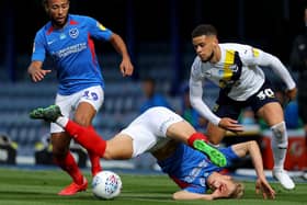 PORTSMOUTH, ENGLAND - JULY 03: Marcus Browne of Oxford United is challenged by Cameron McGeehan of Portsmouth and Ross McCrorie of Portsmouth during the Sky Bet League One Play Off Semi-final 1st Leg match between Portsmouth FC and Oxford United at Fratton Park on July 03, 2020 in Portsmouth, England. Football Stadiums around Europe remain empty due to the Coronavirus Pandemic as Government social distancing laws prohibit fans inside venues resulting in all fixtures being played behind closed doors. (Photo by Warren Little/Getty Images)
