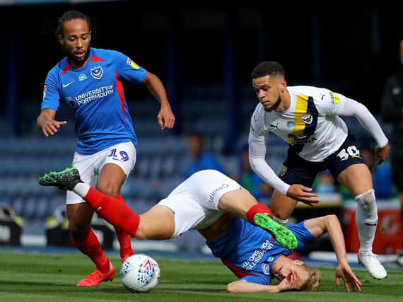 PORTSMOUTH, ENGLAND - JULY 03: Marcus Browne of Oxford United is challenged by Cameron McGeehan of Portsmouth and Ross McCrorie of Portsmouth during the Sky Bet League One Play Off Semi-final 1st Leg match between Portsmouth FC and Oxford United at Fratton Park on July 03, 2020 in Portsmouth, England. Football Stadiums around Europe remain empty due to the Coronavirus Pandemic as Government social distancing laws prohibit fans inside venues resulting in all fixtures being played behind closed doors. (Photo by Warren Little/Getty Images)
