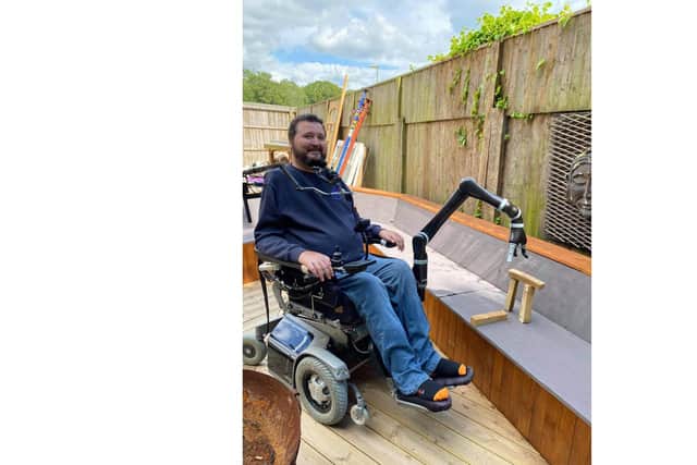 Former paratrooper Jon Noble from Havant, pictured using his new JACO assistive robotic arm.